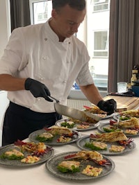 a chef is preparing food on plates